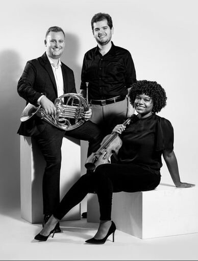 A black and white photo of the black moon trio