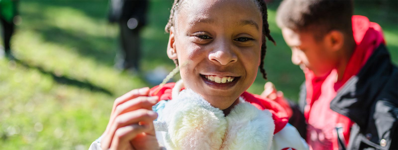 A girl smiling in a grassy field during a nature walk