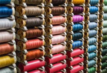 Dozens of differently colored spools of thread