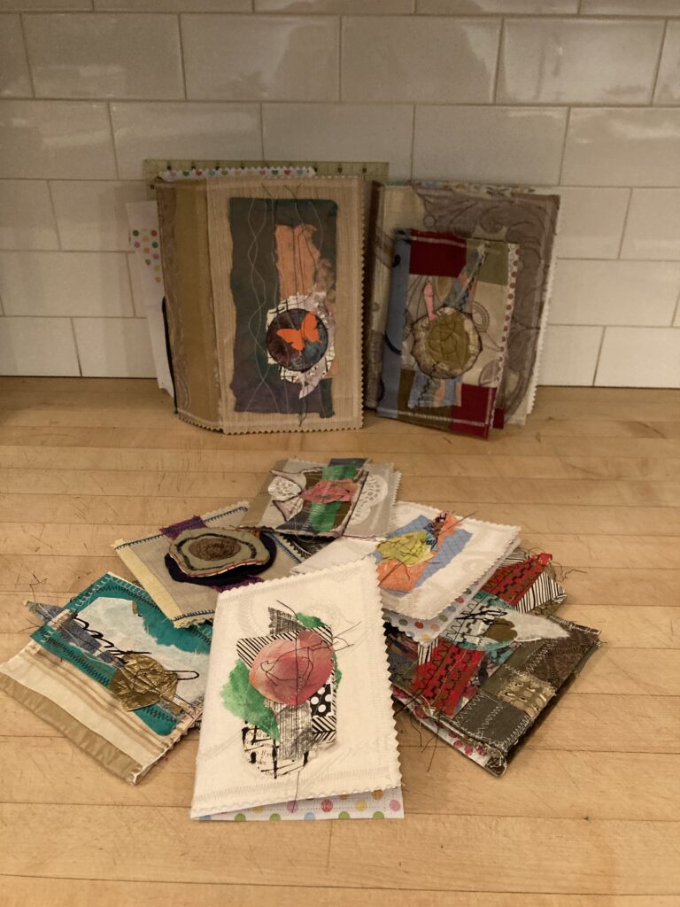 A collection of junk journals, handmade books made of various materials.