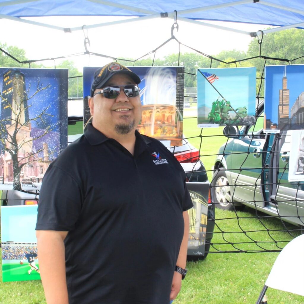 Jerry Loza at his booth at an art fair.